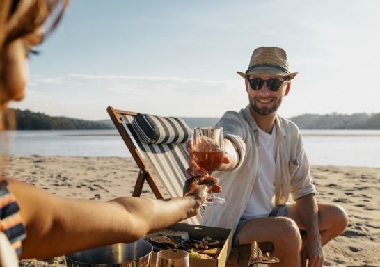 Couple drinking wine on the beach